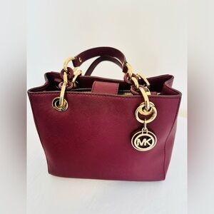 Michael Kors Saffiano leather satchel bag with gold tone hard wear.